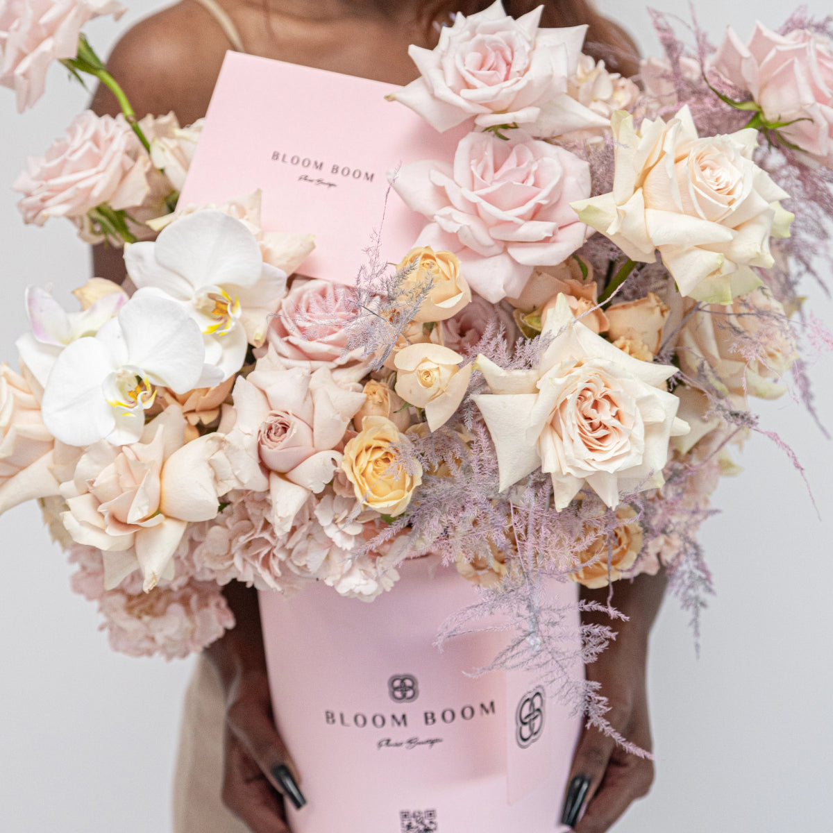 Pink Bloom Boom flower box with blush roses, white orchids, and dusty miller foliage arrangement