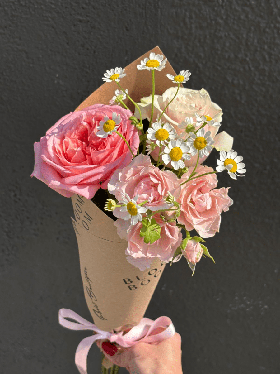 The Tutu Bouquet — 4-stem mini bouquet of pink roses and white chamomile in a kraft-paper cone, by Bloom Boom for Tutu School