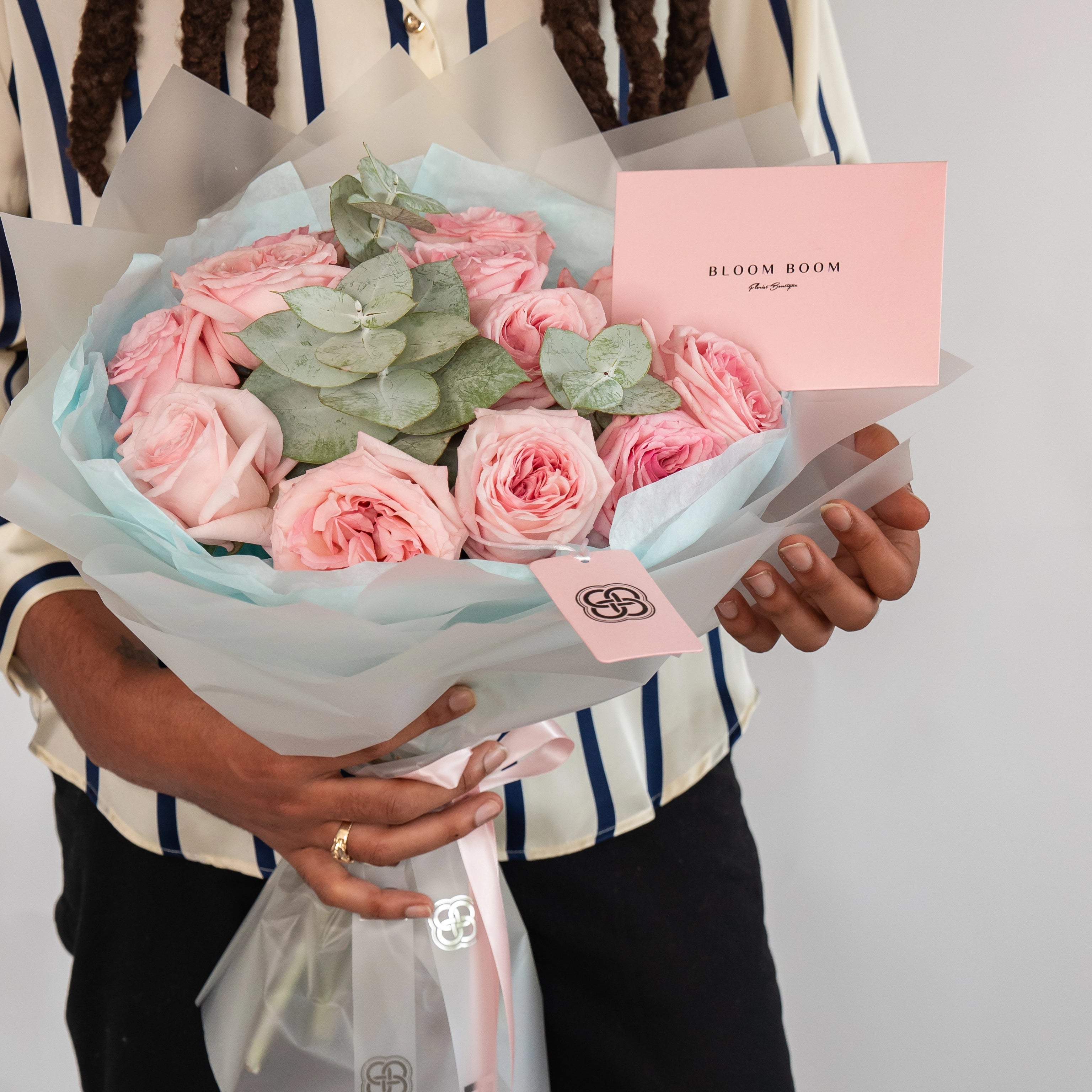 Blush pink garden rose bouquet with eucalyptus wrapped in white paper from Bloom Boom Flowers Los Angeles florist