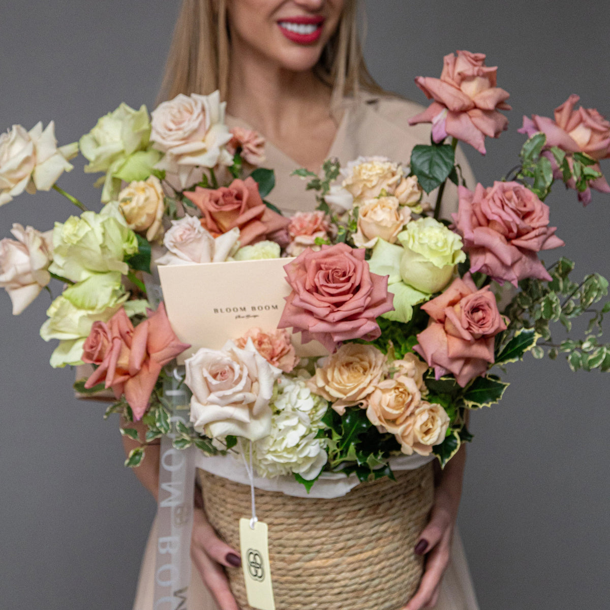 Luxury flower basket with pink, cream and green roses, white hydrangeas in natural rope-wrapped container