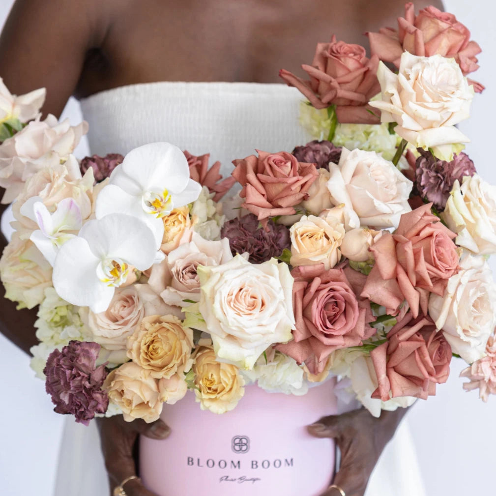Luxury pink flower box with white orchids, blush roses, burgundy carnations and hydrangeas in round hatbox