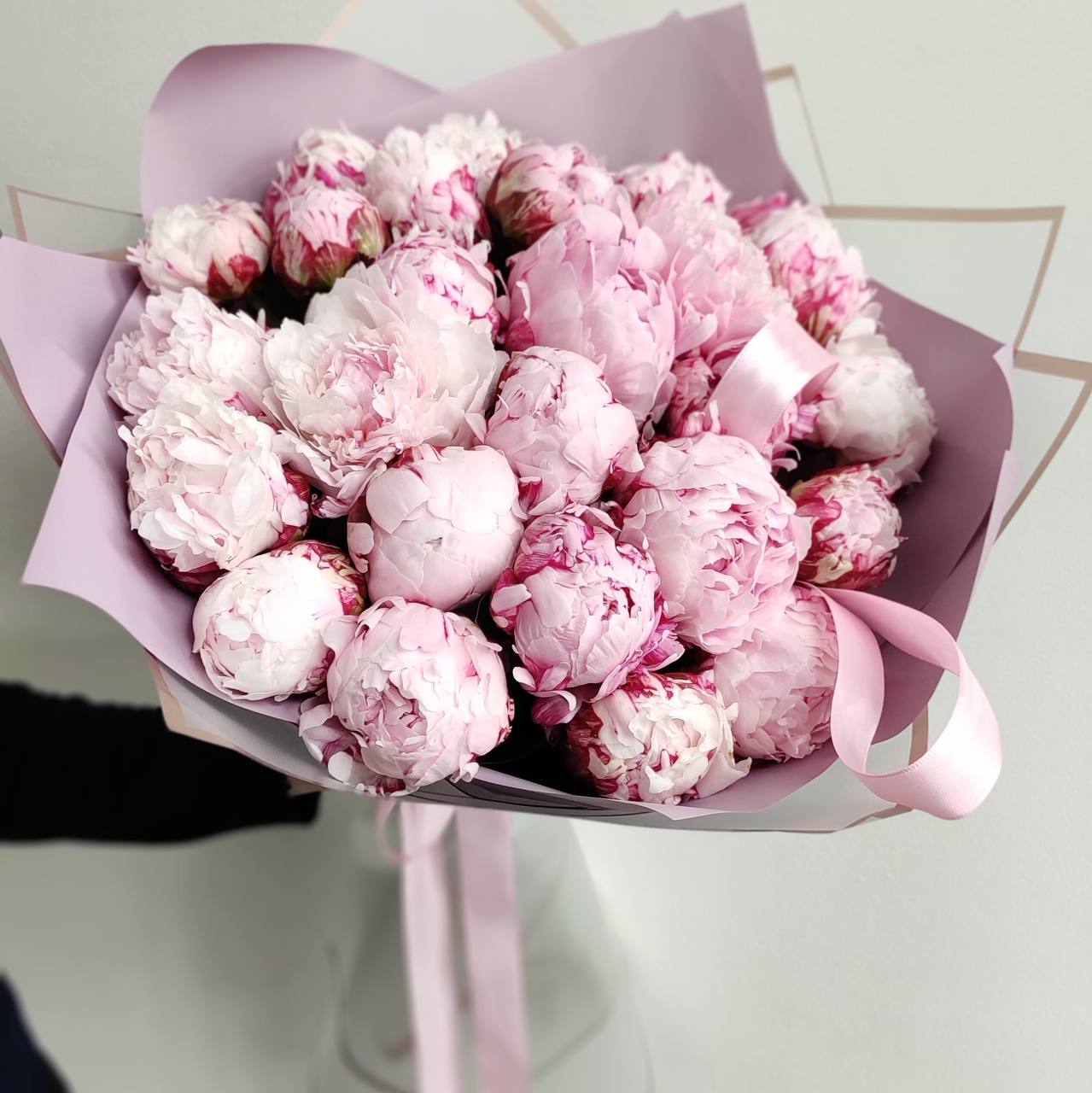 Pink and white peony bouquet with burgundy edges wrapped in lavender paper with pink ribbon for Los Angeles delivery