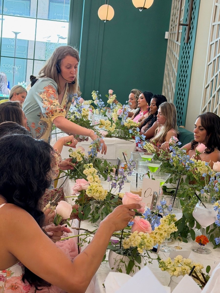A Bloom Boom florist guiding guests through a hands-on flower-arranging workshop in Los Angeles.