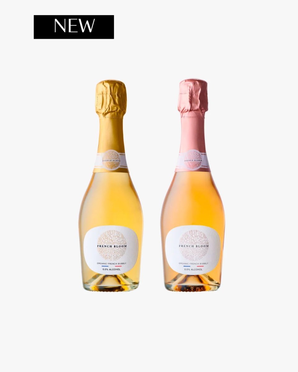 Two French Bloom organic sparkling bottles with gold and pink foil tops, white oval labels on light background